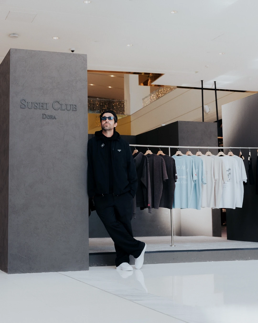 Chris Stamp standing in front of Sushi Club apparel